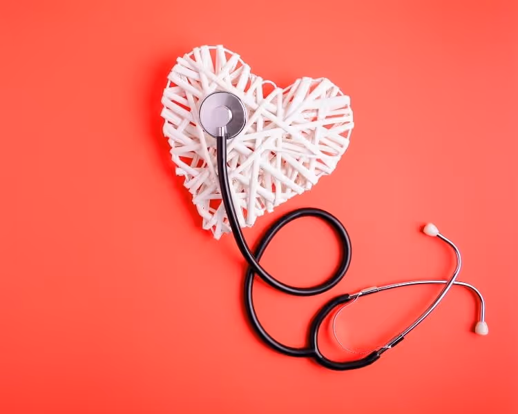 White heart and stethoscope on red background