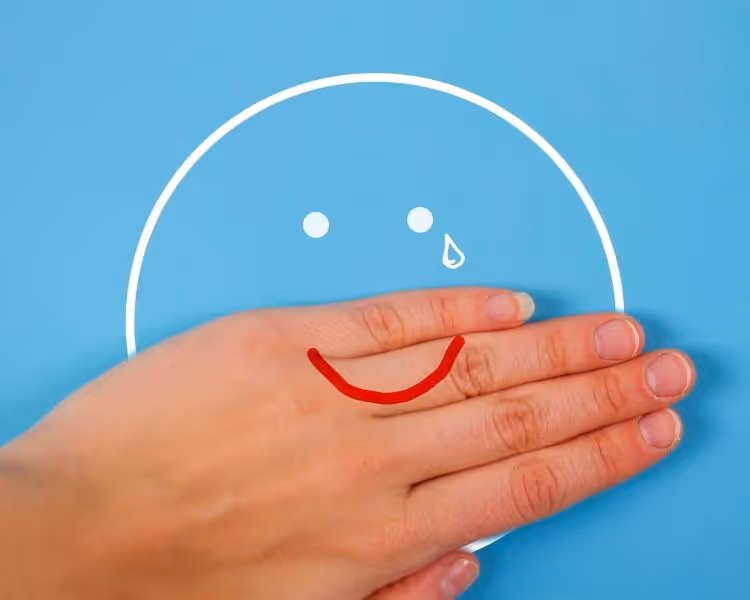 Happy face with tear drop on blue background