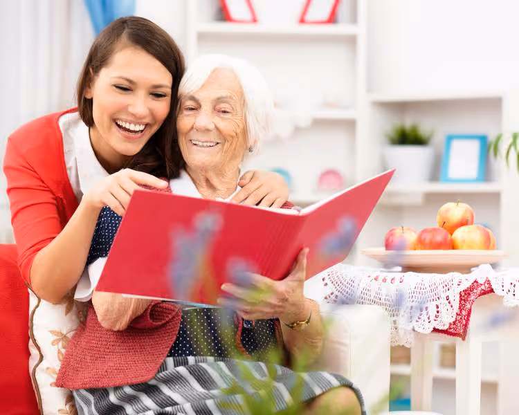 daughter reading with her mom who has dementia
