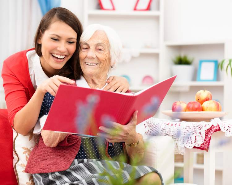 daughter reading with her mom who has dementia