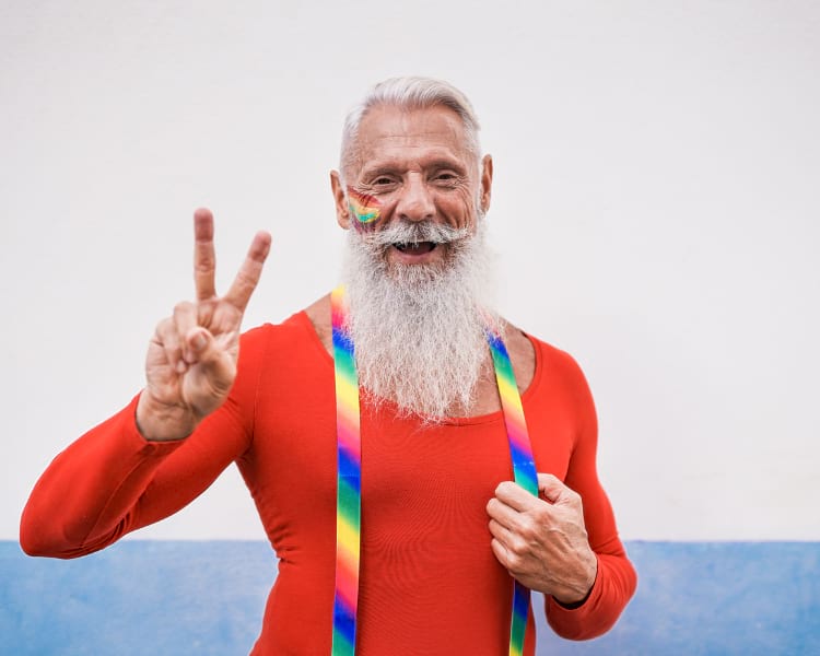 a senior man wearing rainbow suspenders