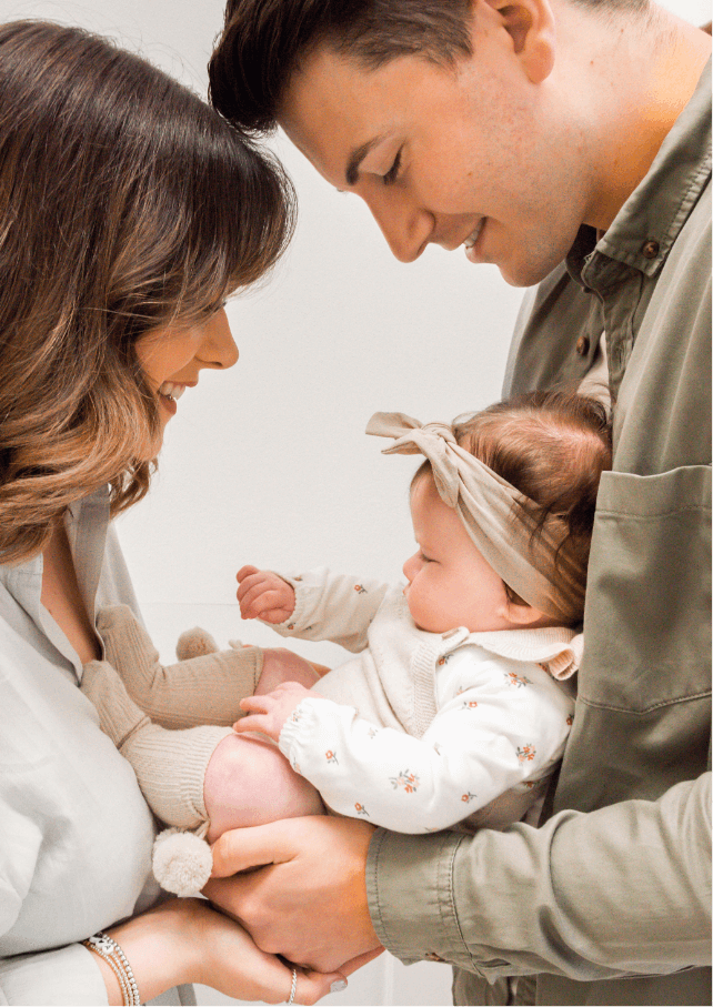 A beautiful photo of parents gazing fondly down at their baby girl. Gemma Randall Photography ©