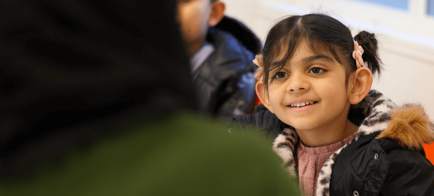young girl smiling at her tutor