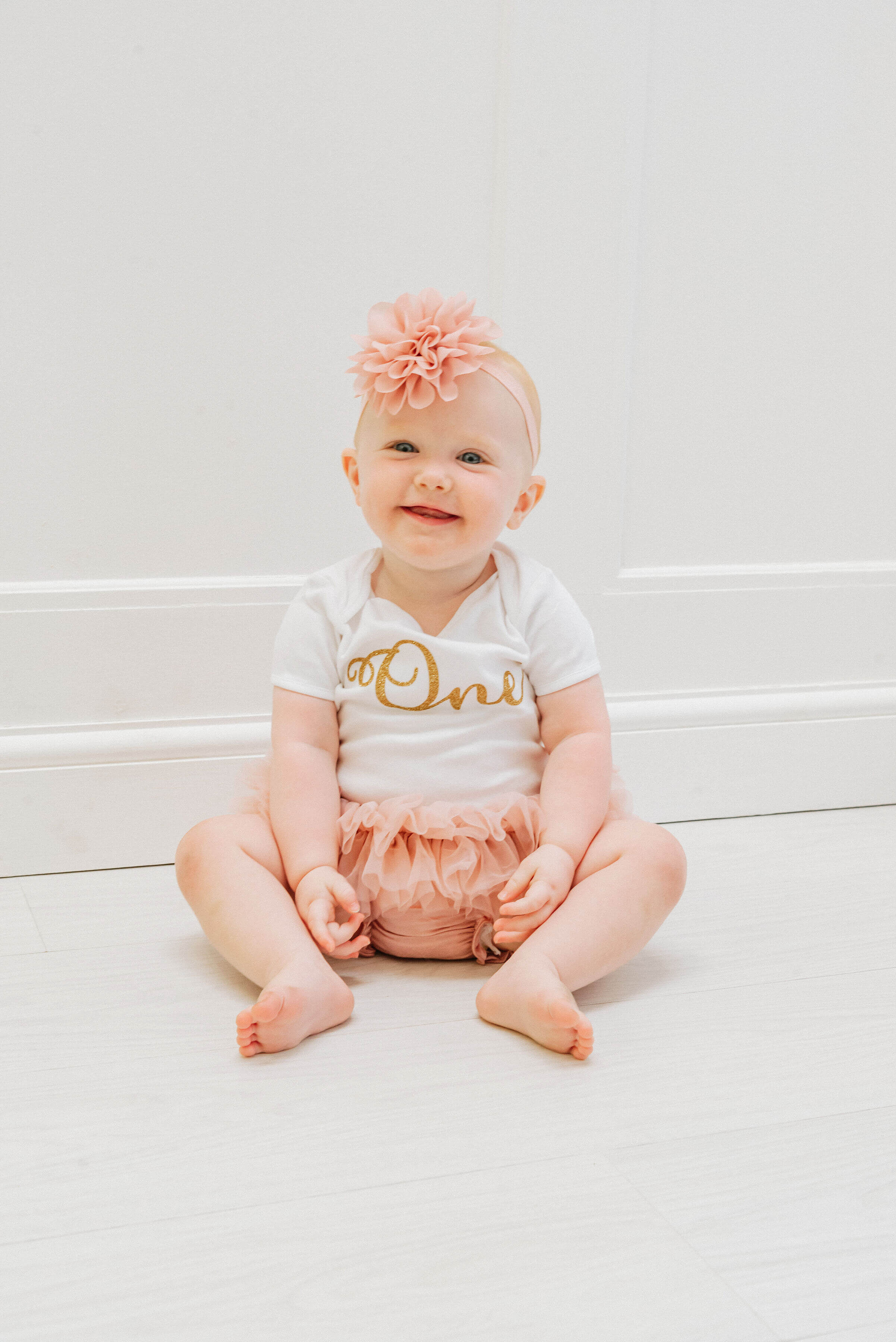 Baby Delilah cheekily grinning into the camera, shot by Gemma Randall ©