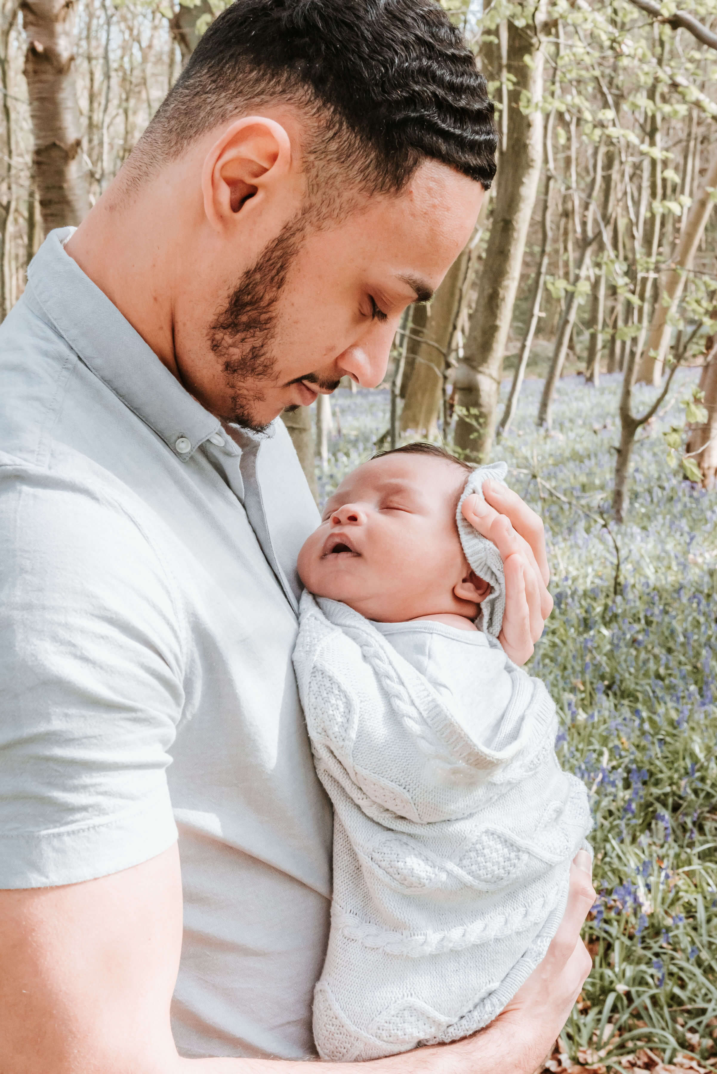 Aaron looking at Baby Ovie, The Scantlebury Family, shot by Gemma Randall ©
