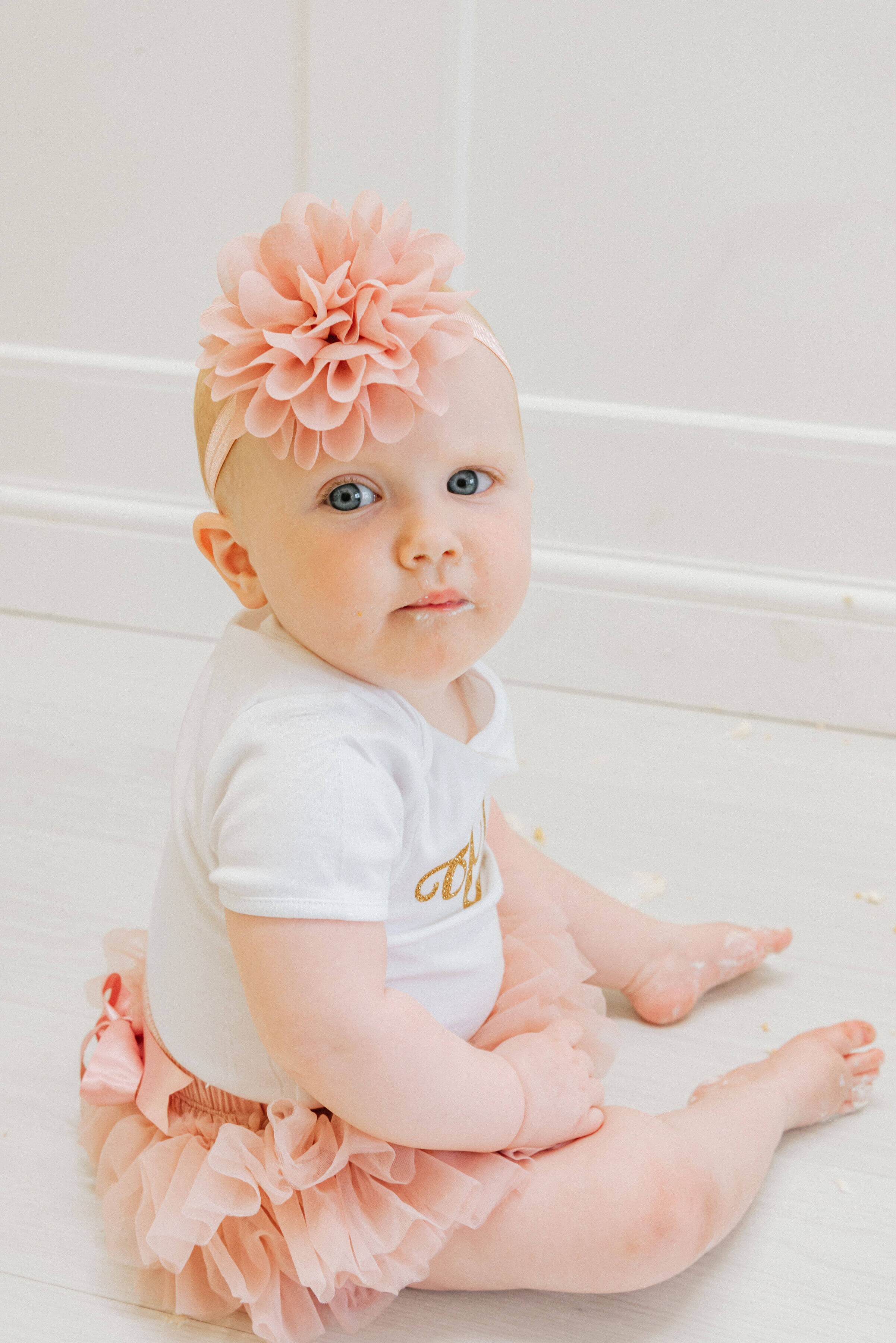 Baby Delilah with cake on her face shot by Gemma Randall ©