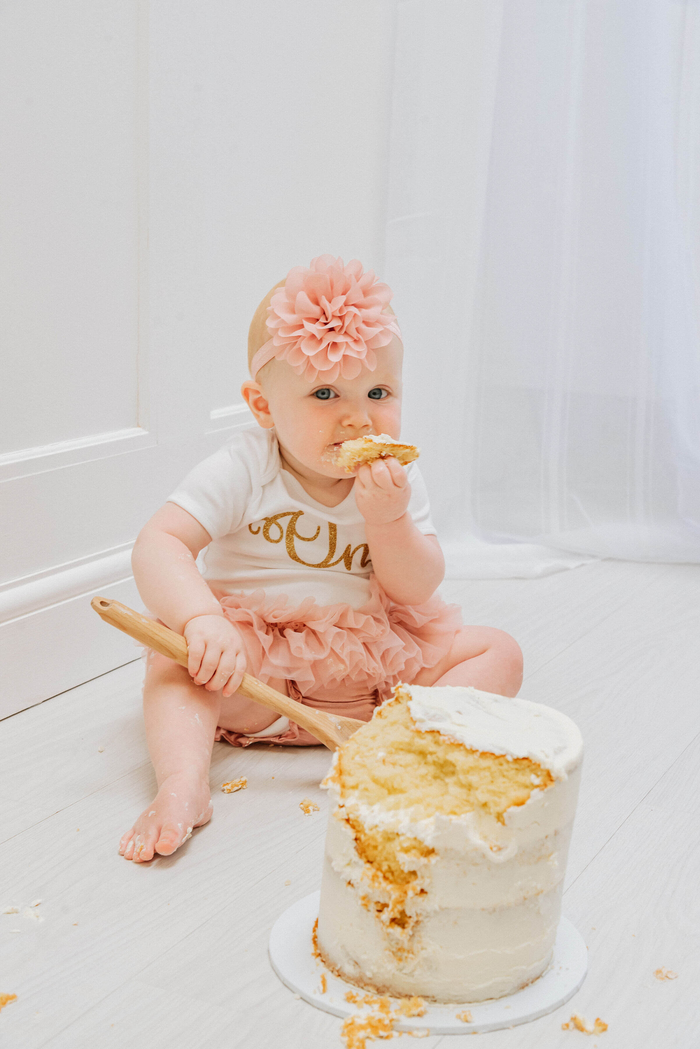 Baby Delilah messily munching on her cake, shot by Gemma Randall ©