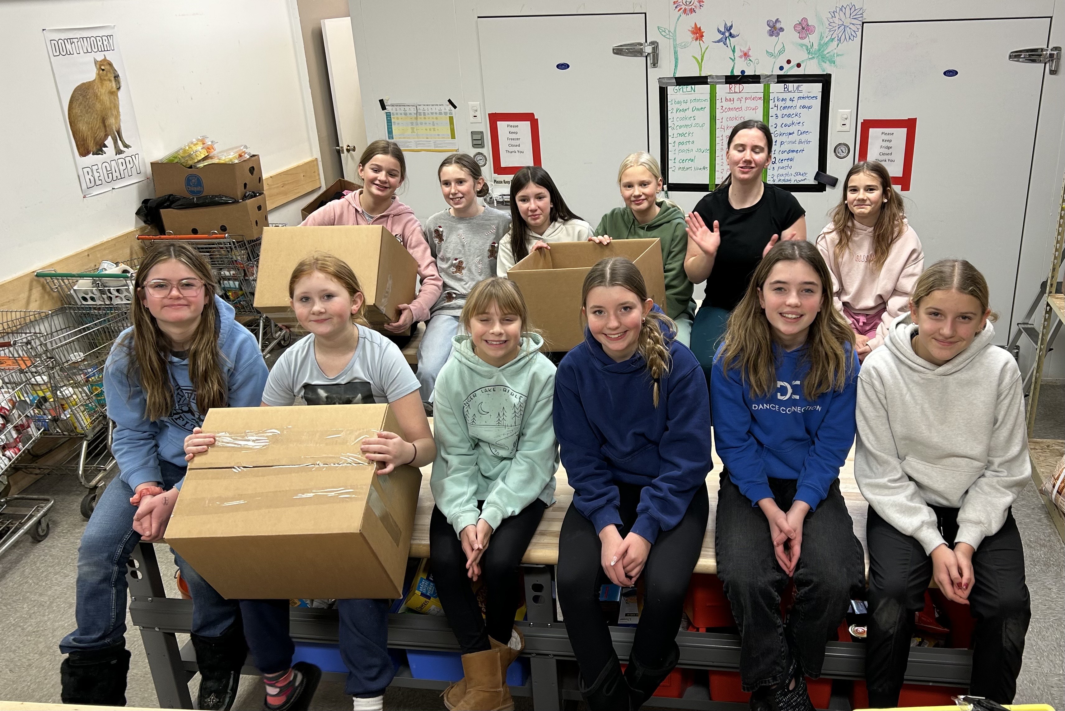 Students from Battlefords Central School assembling Christmas hamper boxes for kids and families.