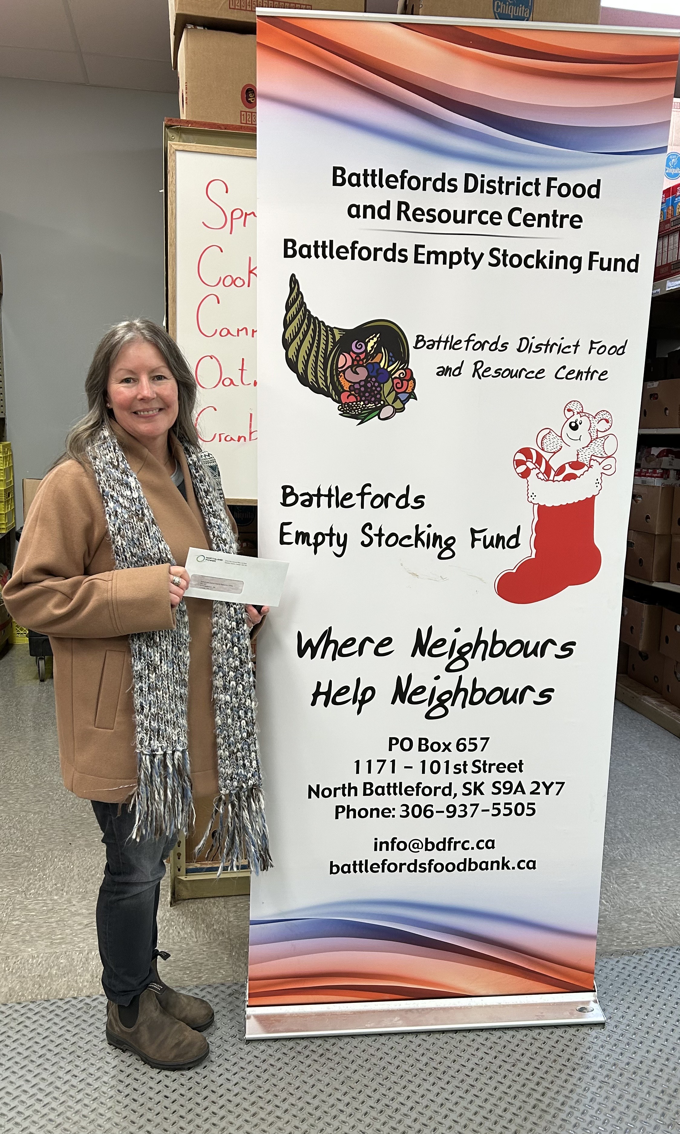 Northland Power presenting a cheque as a monetary donation to support Christmas programs for kids.