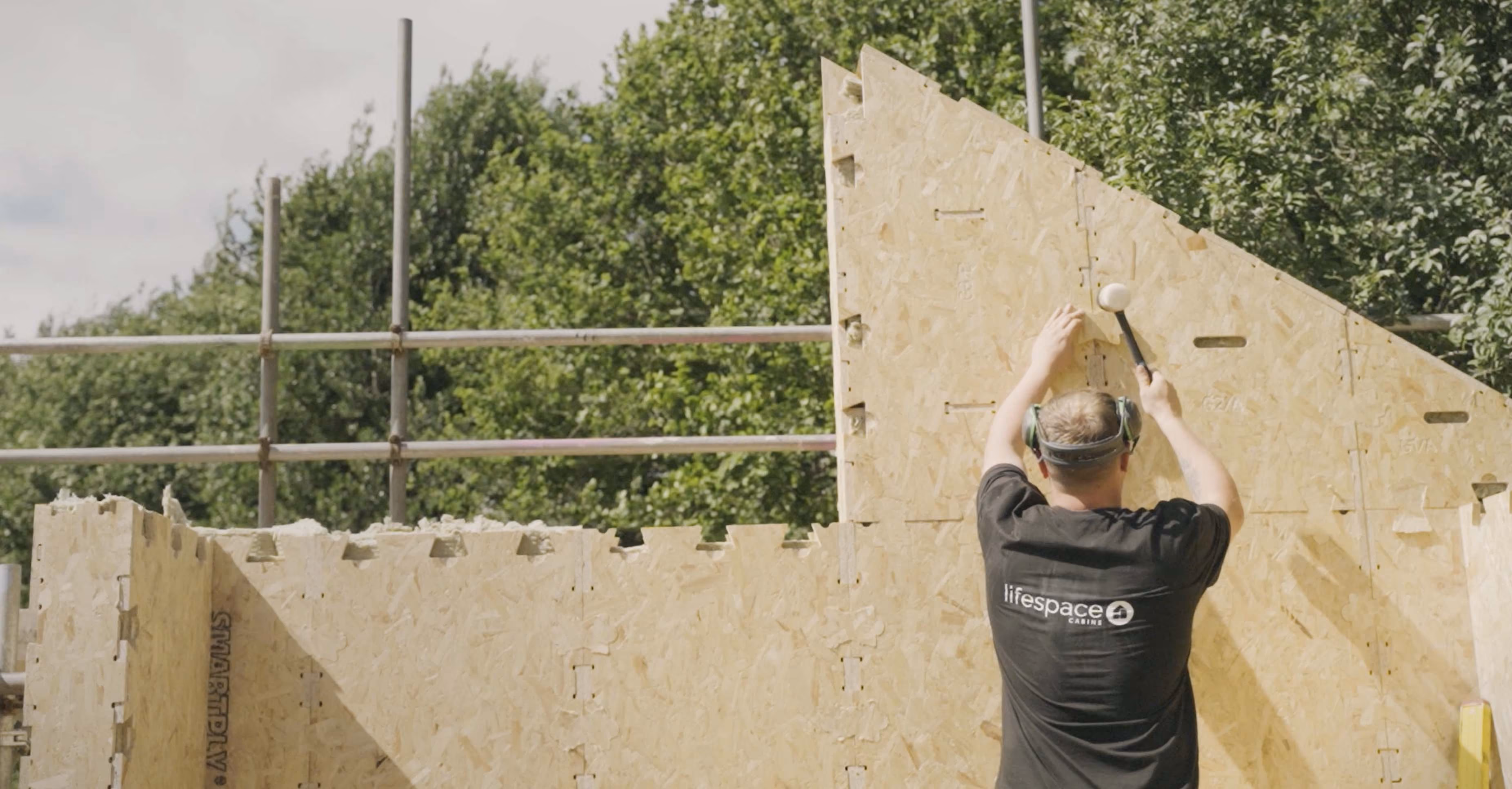 Builder assembles WikiHouse wall.