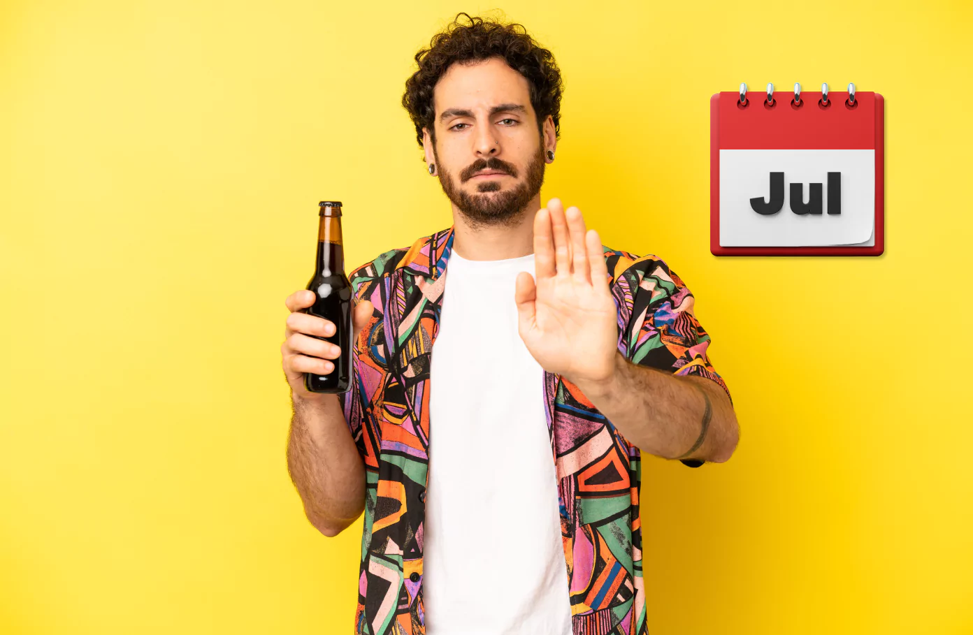 A man holding a beer and using his other hand to make a stop gesture