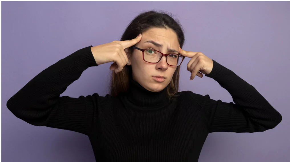 A woman wearing glasses, thinking deeply about something