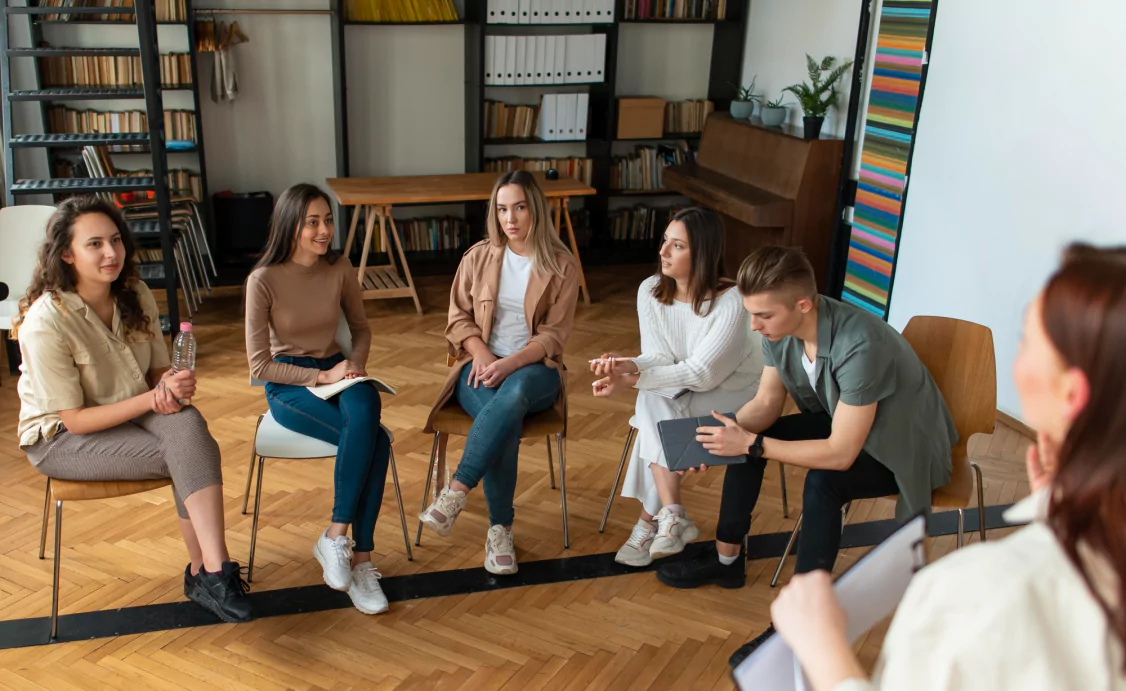 A multicultural gathering sharing ideas in a circle