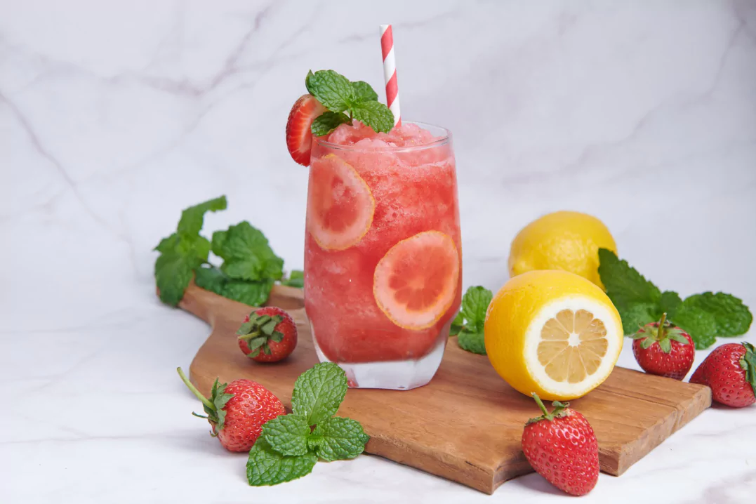 A healthy mocktail garnished with lime and herbs