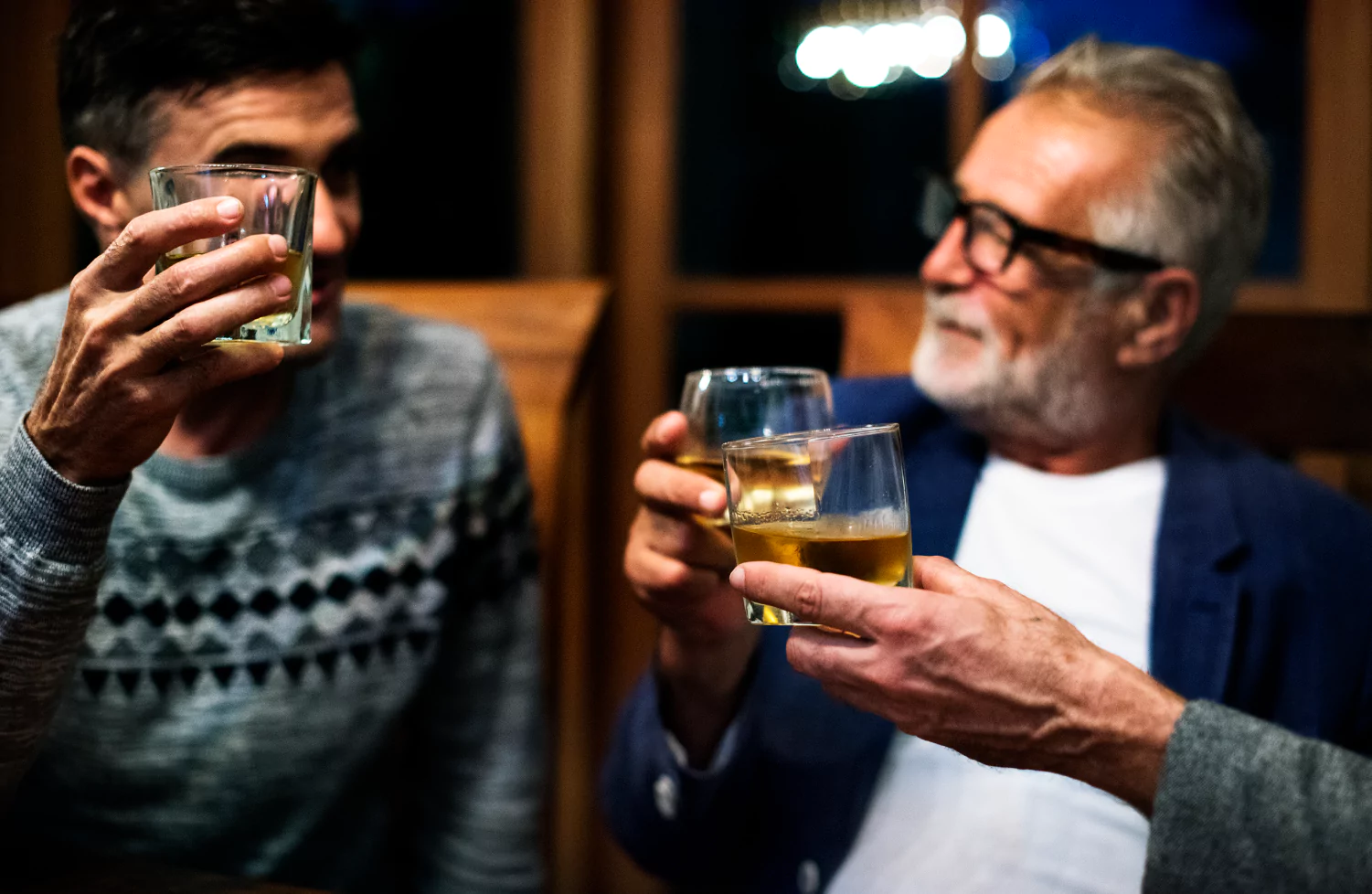 men raising wine glasses in celebration