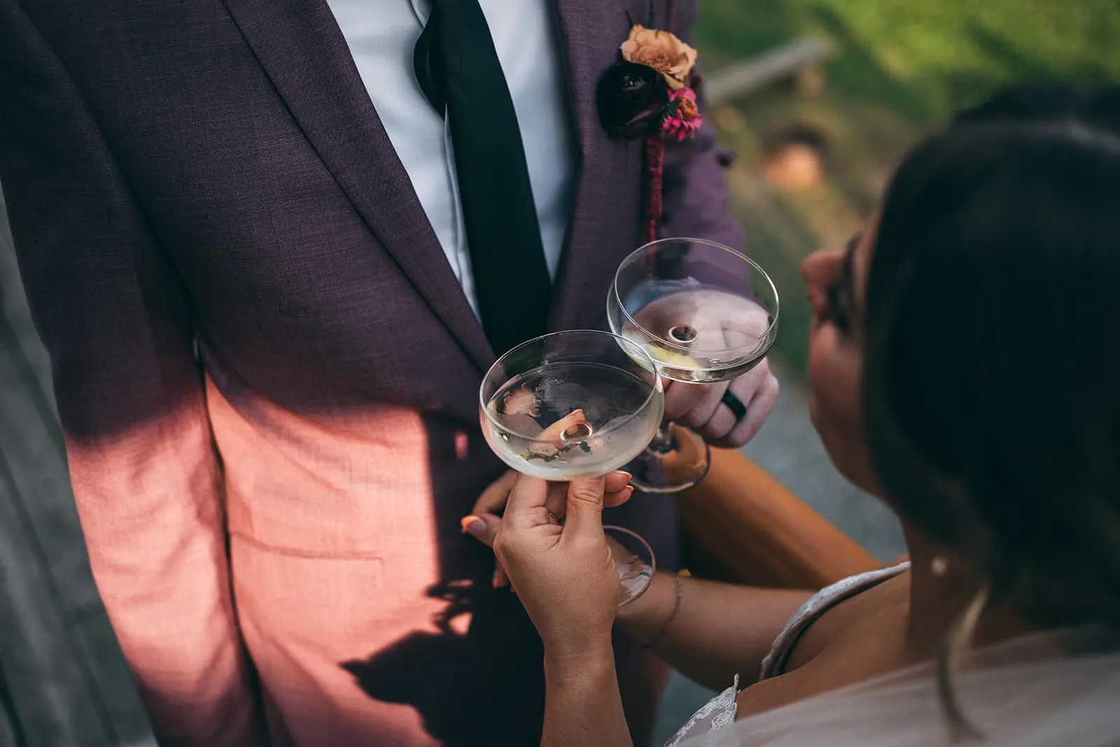 A wedding couple holding two champagne glasses