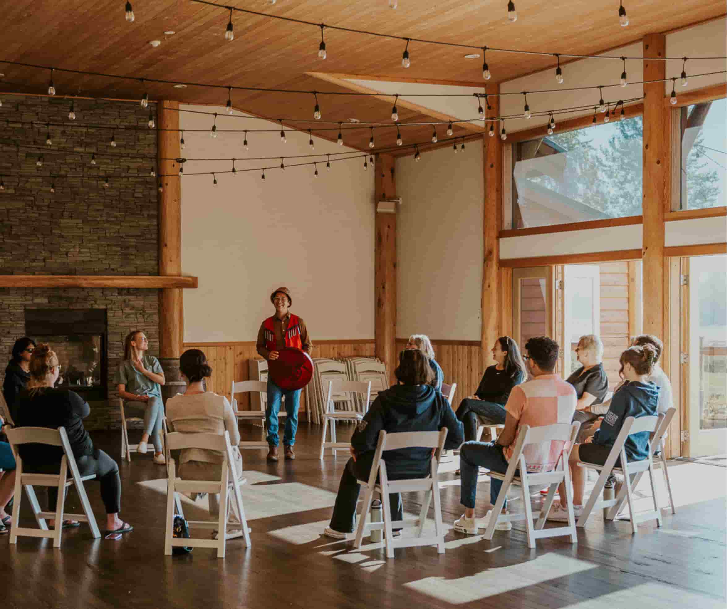 A corporate group being led through an Indigenous meditation at Fraser River Lodge.