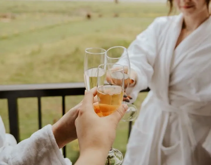 A fraser river lodge guest enjoying a drink in a bathrobe on the deck post hot tub