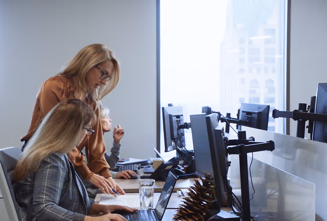 Instructor guiding employee at the desk