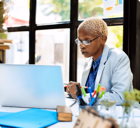 lady smiling while using a laptop