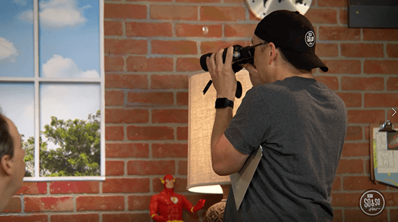 A man with a black cap using binoculars at Pequea Church