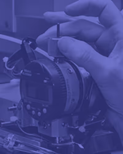 Hand adjusting a mechanical device with a digital display and dials.