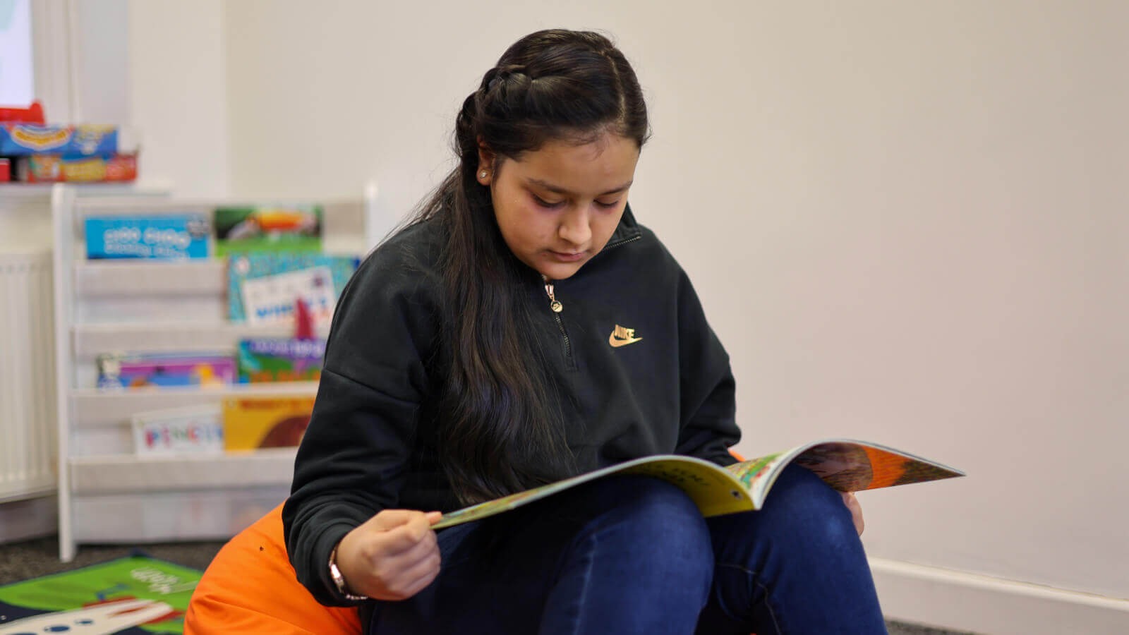 Student reading to maintain summer momentum