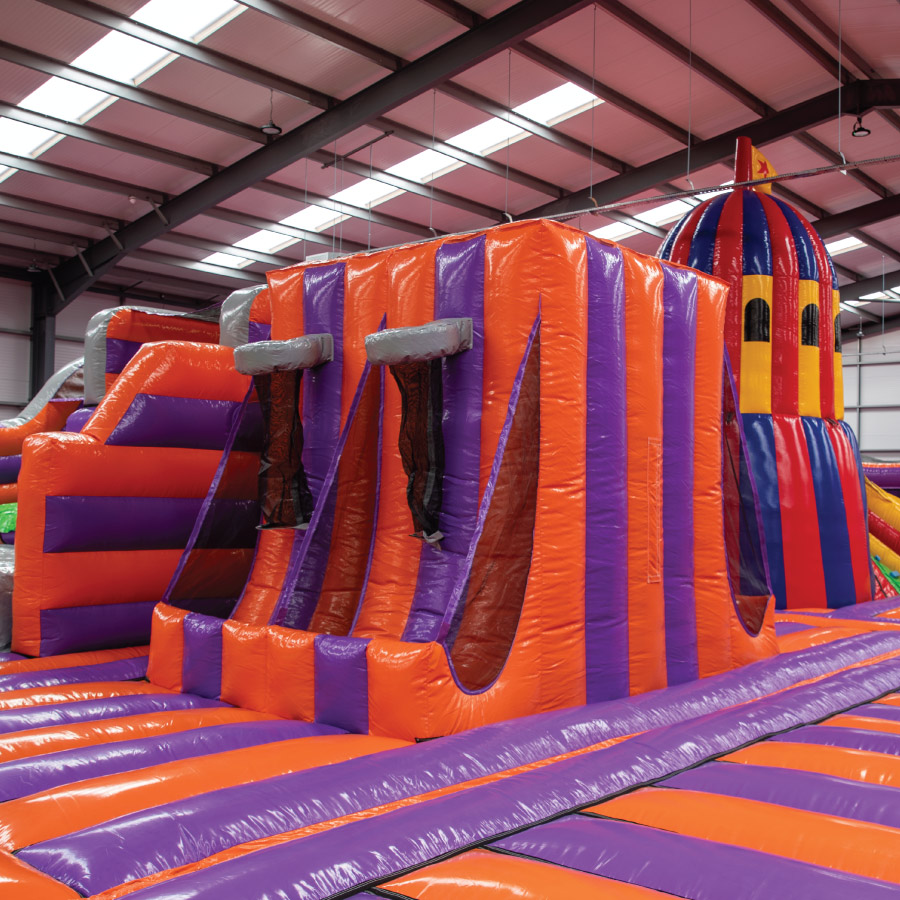 Happy kids running onto an inflatable playground