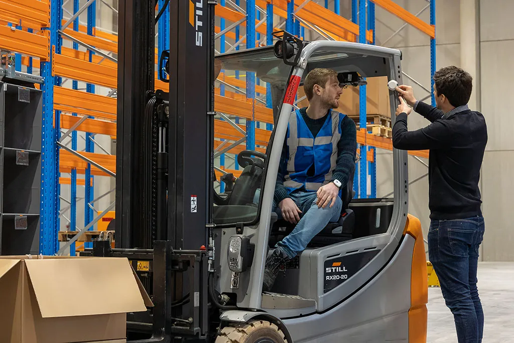 A Pozyx Industrial tag being attached to a forklift