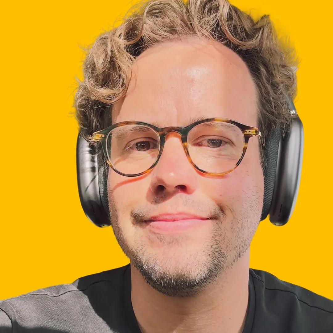 Alan Dangerfield's headshot against a yellow background