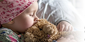 Image of a baby holding a teddybear
