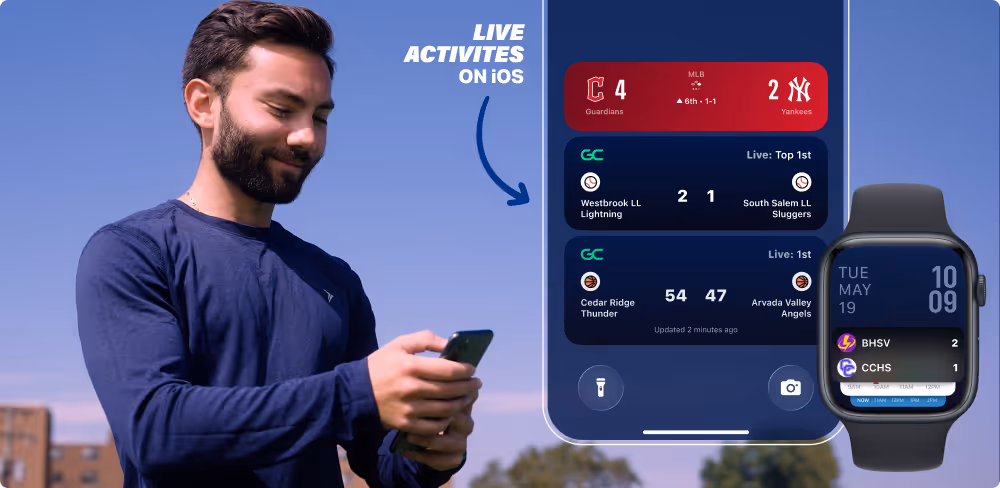 Man looking at phone showing live sports scores with iPhone and Apple Watch displaying games on iOS Live Activities.