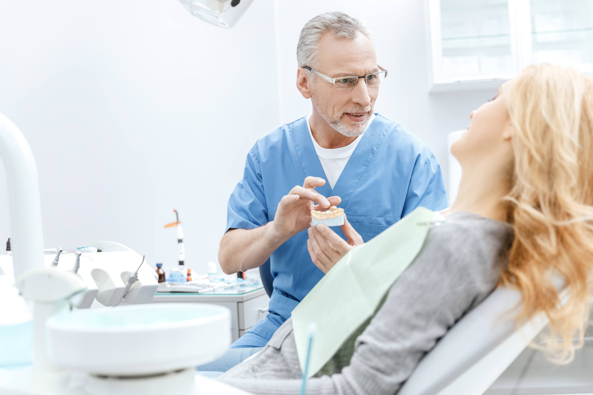 Dentist in Fort Lauderdale explaining to female patient