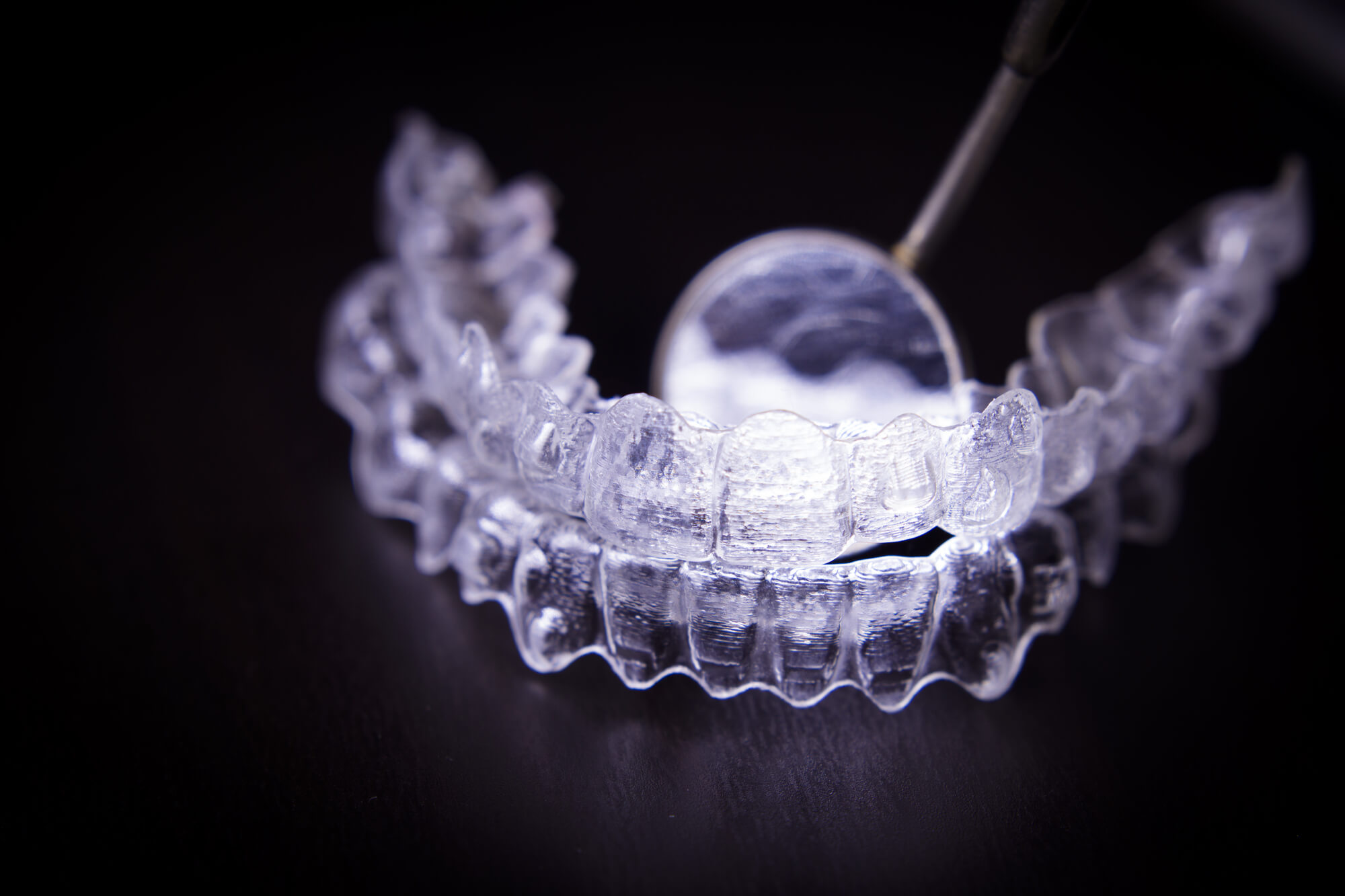 Invisalign in Fort Lauderdale with a dental instrument