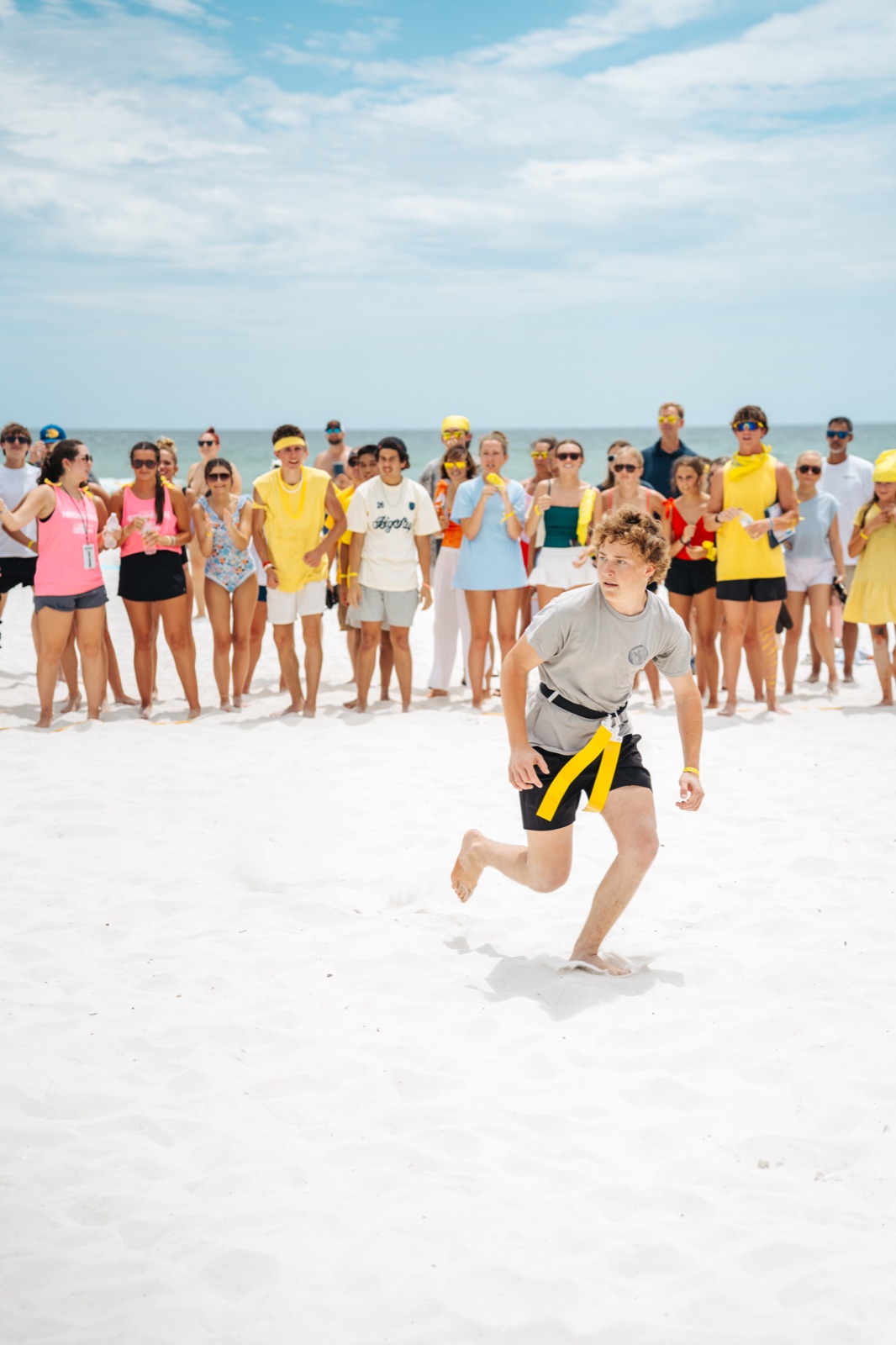 Students and leaders cheering during a BigStuf 2026 beach activity
