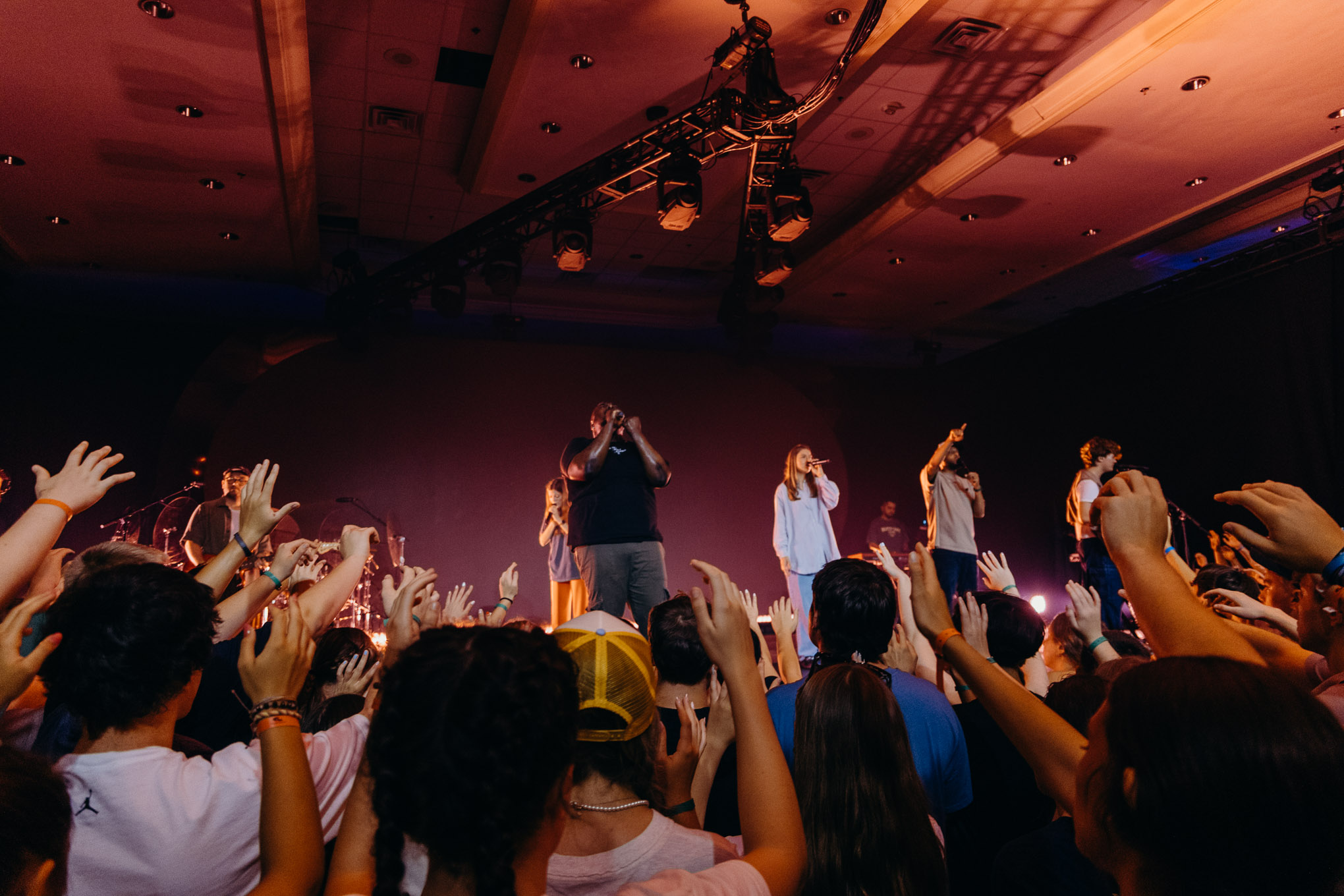 Students worshiping with raised hands