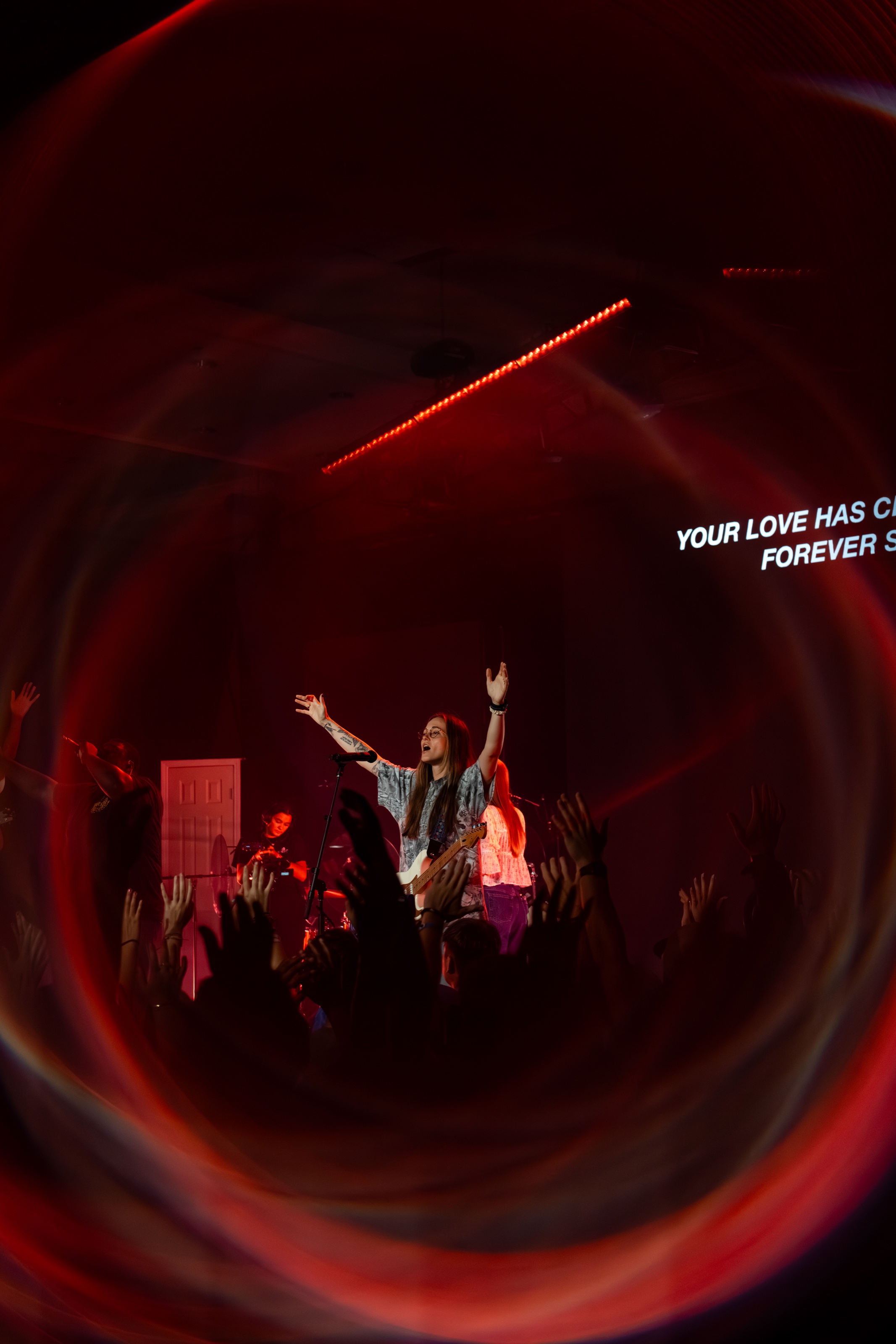 A BigStuf worship leader with students during an auditorium session