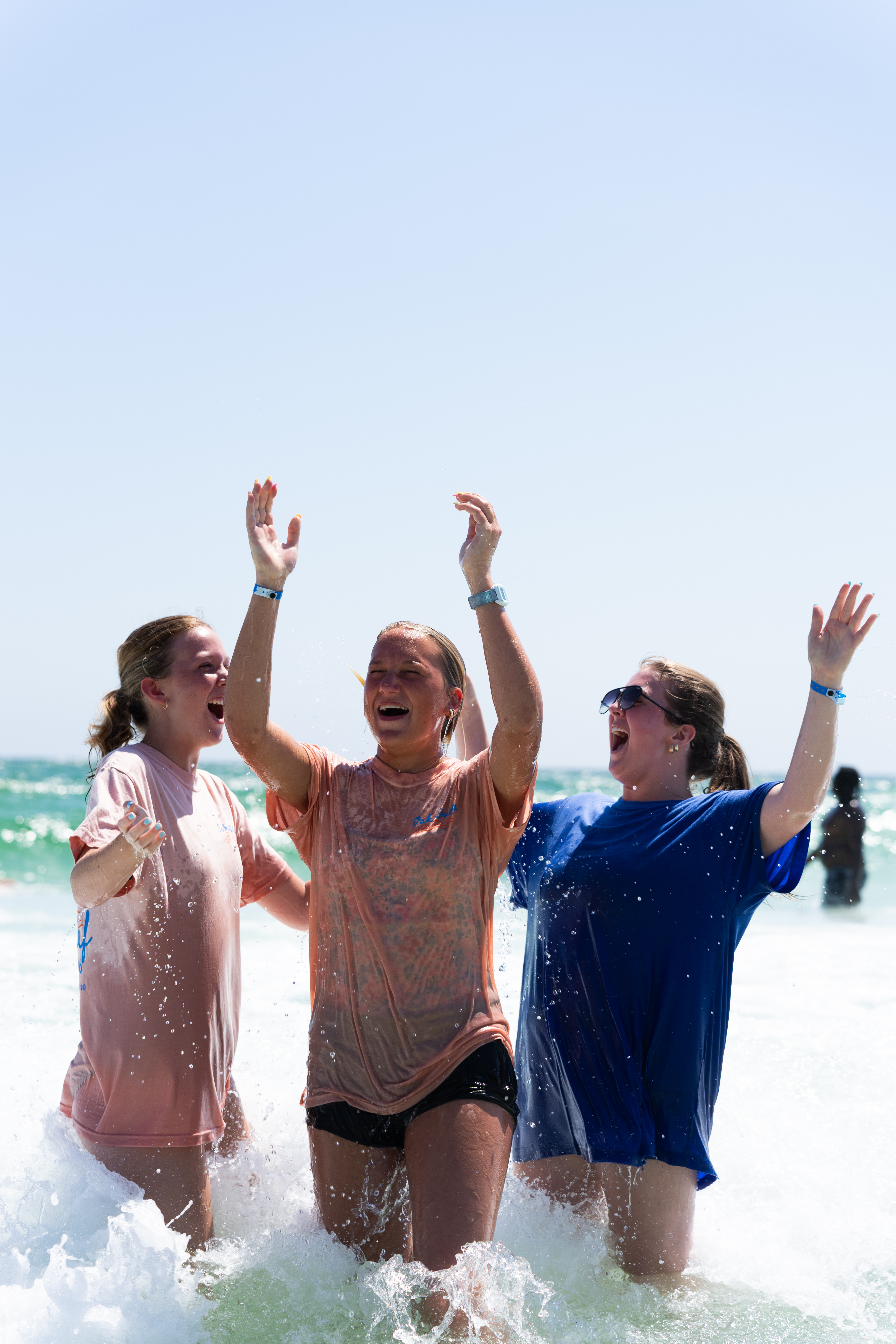 Students and leaders celebrating a baptism in the ocean at BigStuf