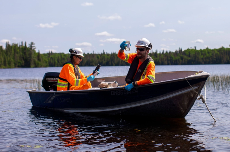 Two enviro-techs taking water samples in one of the many lakes on the Côté Gold site.