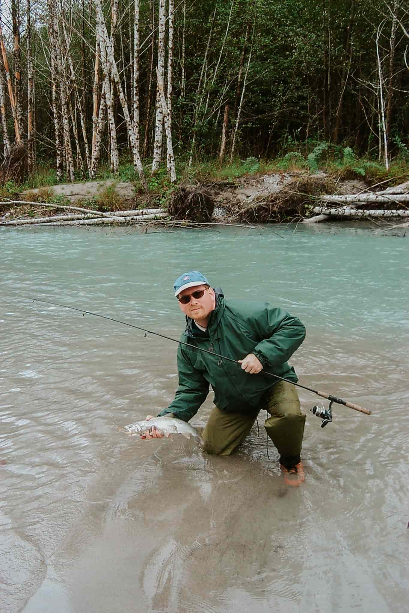 A Fraser River Lodge fishing guest with his bulltrout catch