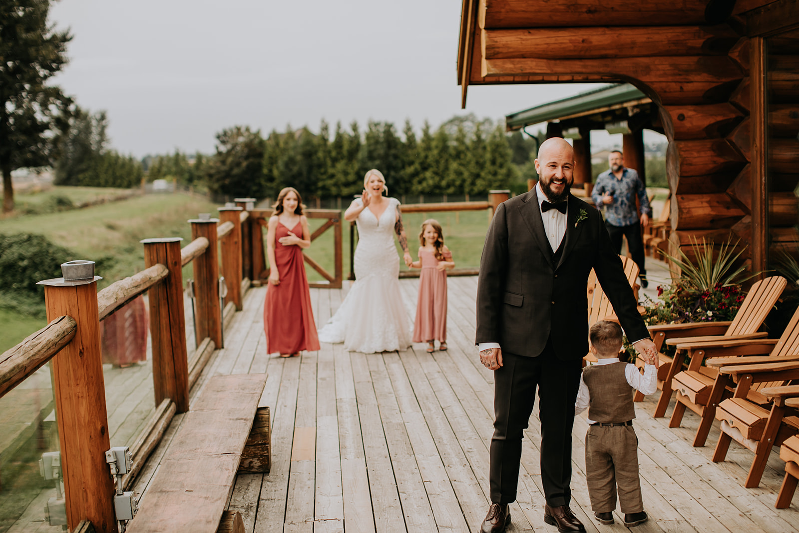 A couple playing with their children on their wedding day