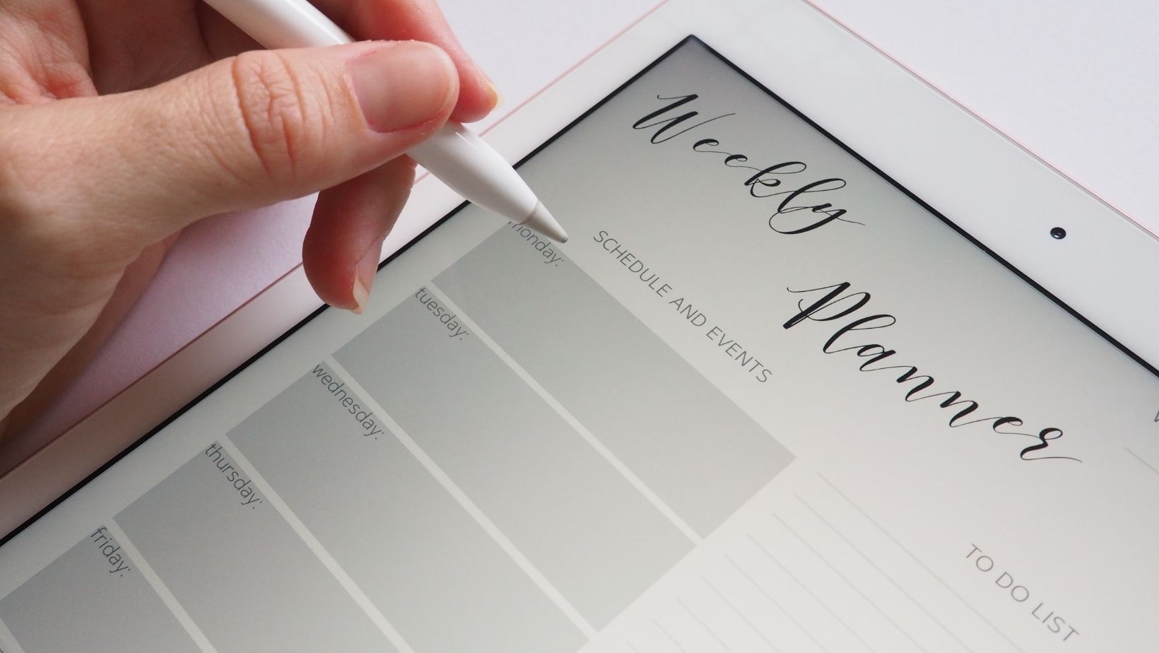 A person writing out their weekly planner