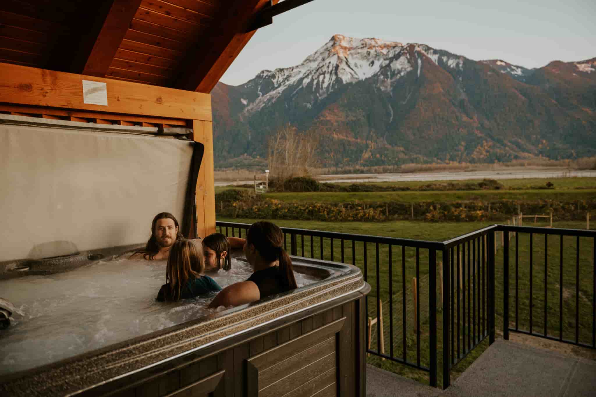 A family at the fraser river lodge in the hot tub