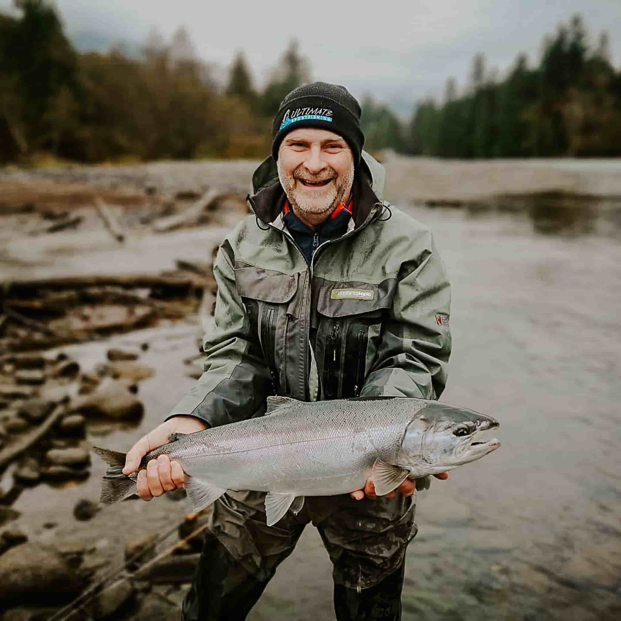 A group of men holding a large salmon 