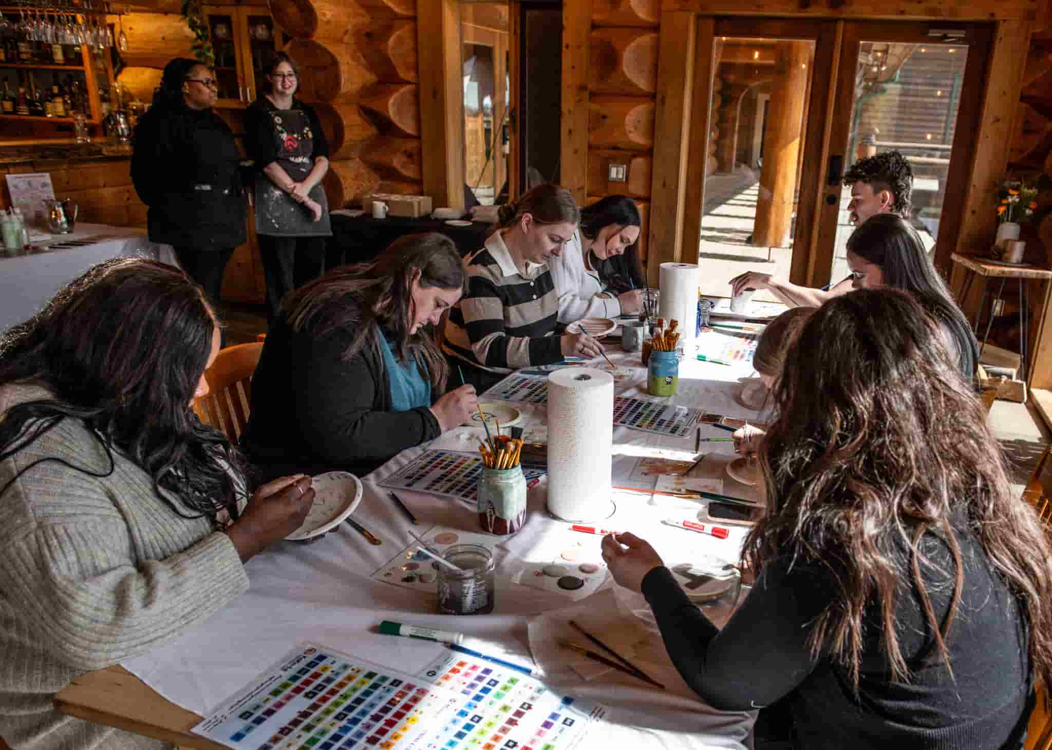 A group painting pottery at the Fraser River Lodge