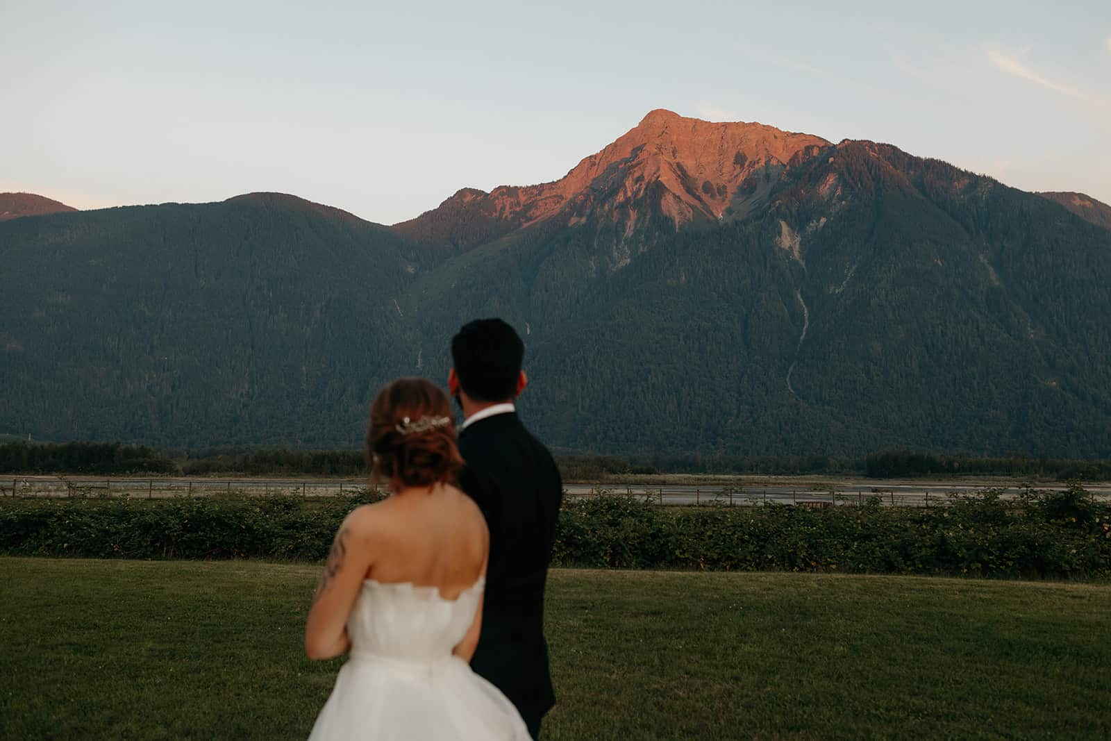 a wedding couple at the Fraser River Lodge looking at a mountain sunset