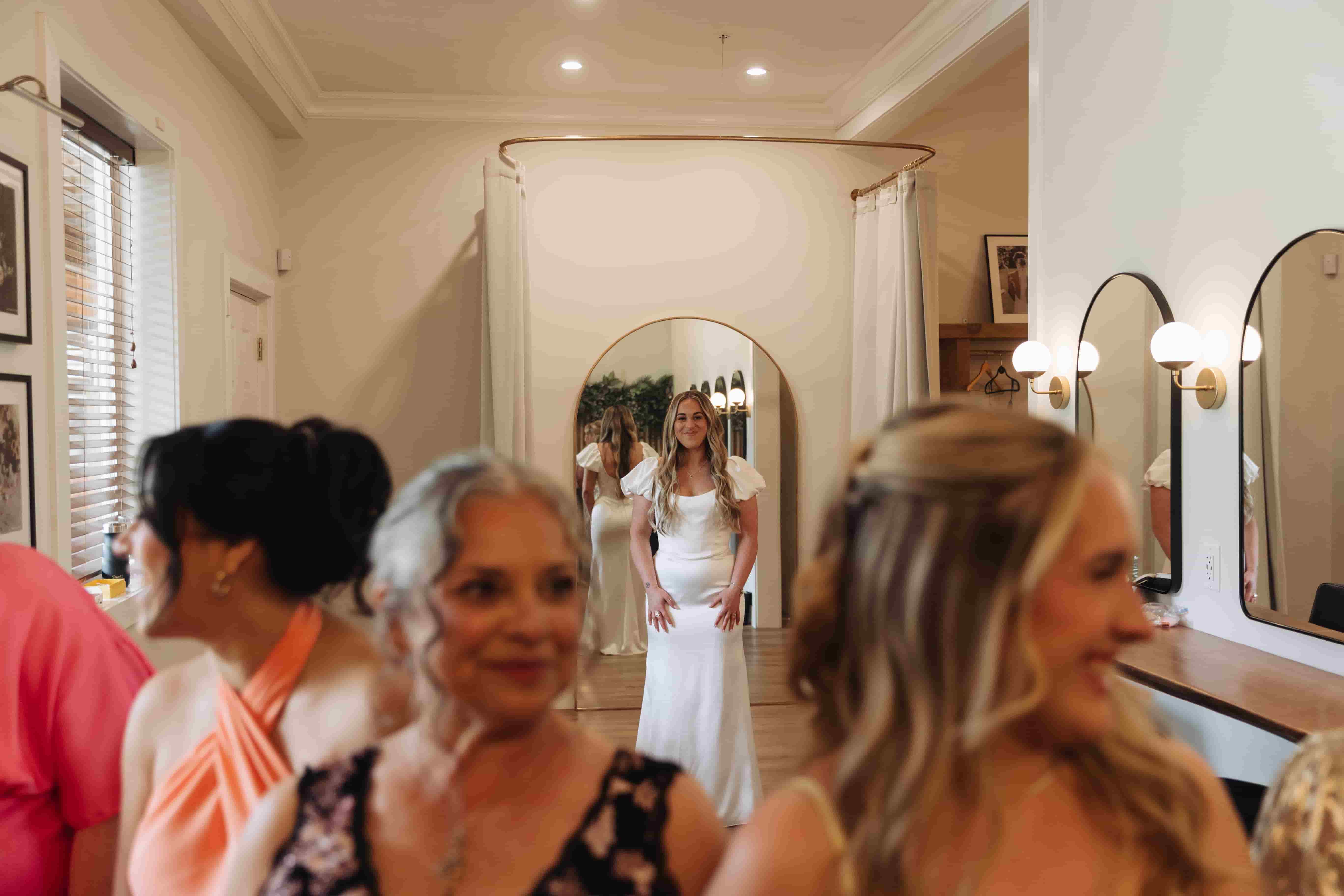 A bride about to do a dress reveal in the Fraser River Lodge's wedding suite