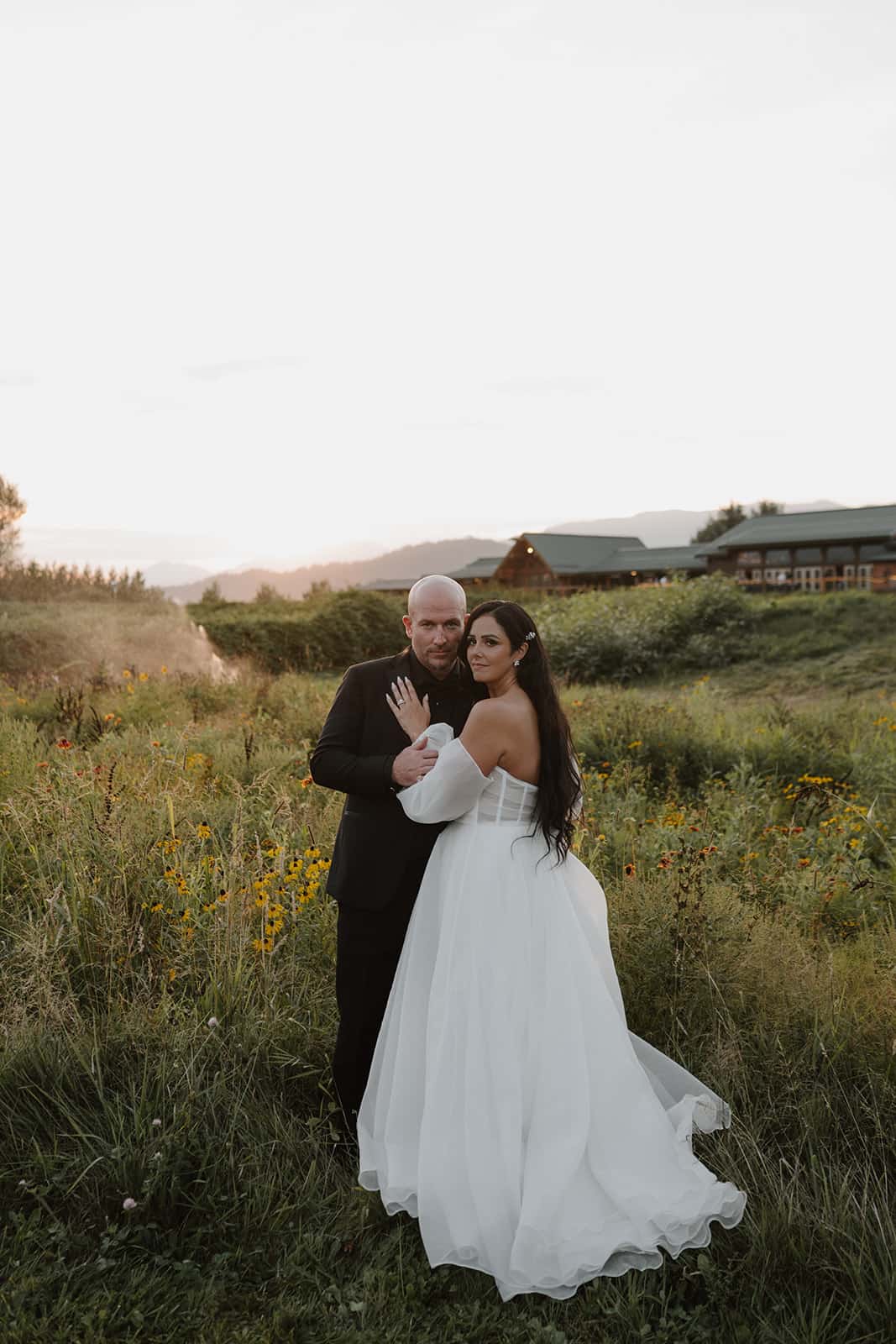 A wedding couple posing in front of the Lodge