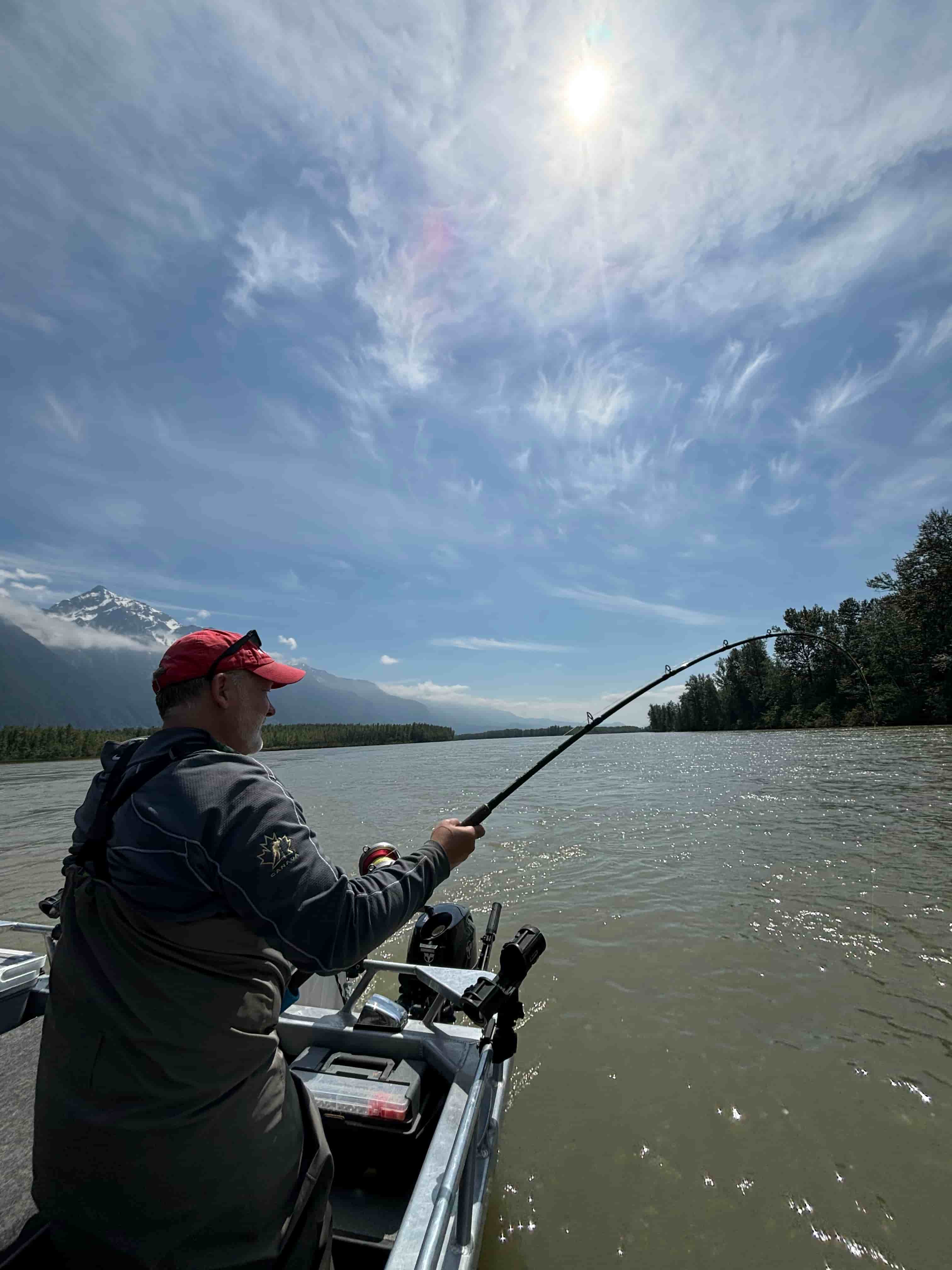 a man with a sturgeon on the line