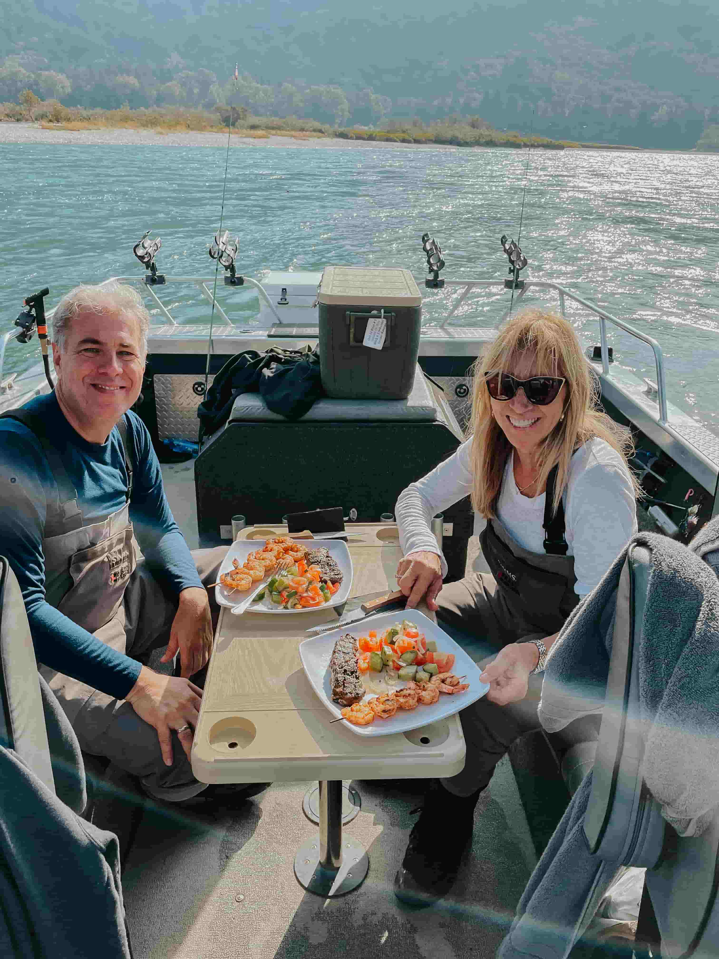 A couple enjoying lunch on the river